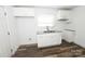 Well-lit kitchen showcasing white cabinets, granite countertops, and modern fixtures at 125 S Ervin Ave, Newton, NC 28658