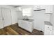Renovated kitchen showcasing modern countertops, white cabinets, and sleek appliances at 125 S Ervin Ave, Newton, NC 28658