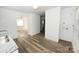 Bright kitchen featuring stainless steel sink, wood-look vinyl flooring, and white walls at 125 S Ervin Ave, Newton, NC 28658