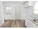Well-lit kitchen featuring white cabinetry, modern sink, and stylish flooring at 125 S Ervin Ave, Newton, NC 28658