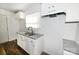 The kitchen boasts granite countertops, bright white cabinets, and modern fixtures at 125 S Ervin Ave, Newton, NC 28658