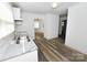 Bright kitchen with stainless steel sink, granite countertops, and wood-look vinyl flooring at 125 S Ervin Ave, Newton, NC 28658