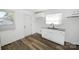 Bright kitchen boasts white cabinets, granite countertops, and stylish flooring at 125 S Ervin Ave, Newton, NC 28658