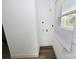 Clean laundry area with new flooring and utility hookups, illuminated by a window at 125 S Ervin Ave, Newton, NC 28658