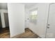 Bright laundry room with new flooring, washer/dryer hookups, and natural light at 125 S Ervin Ave, Newton, NC 28658