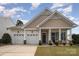 Inviting home with a two-car garage, beautiful trim, and a well-manicured lawn and landscaped yard at 151 Glade Valley Ave, Mooresville, NC 28117