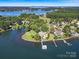 Breathtaking aerial view of a lakeside home with lush greenery, private dock, and tranquil waters at 18212 Pompano Pl, Cornelius, NC 28031