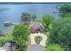 Aerial view showcasing the waterfront property with private dock, lush landscaping, and expansive lake at 18212 Pompano Pl, Cornelius, NC 28031