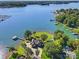 Stunning aerial view of waterfront property with lush landscaping, private dock, and peaceful lake setting at 18212 Pompano Pl, Cornelius, NC 28031