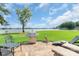 Outdoor patio featuring a stainless steel grill overlooking the lake at 18212 Pompano Pl, Cornelius, NC 28031