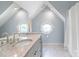 A unique bathroom features dual octagonal windows and granite countertops at 18212 Pompano Pl, Cornelius, NC 28031
