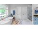 Elegant bathroom featuring a freestanding tub, glass shower, and stylish fixtures at 18212 Pompano Pl, Cornelius, NC 28031
