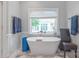 Serene bathroom featuring a soaking tub with a view and modern fixtures at 18212 Pompano Pl, Cornelius, NC 28031