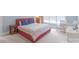 A comfortable bedroom with a large bed, side tables, and sitting area with lots of natural light at 18212 Pompano Pl, Cornelius, NC 28031