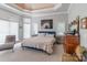 Spacious bedroom with tray ceiling, abundant natural light, and a warm, inviting ambiance at 18212 Pompano Pl, Cornelius, NC 28031