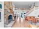 Living room with fireplace, staircase, and hardwood floors throughout at 18212 Pompano Pl, Cornelius, NC 28031