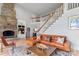 Spacious living room with a fireplace, staircase and built in shelves at 18212 Pompano Pl, Cornelius, NC 28031