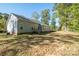 View of the home's backyard, with lush trees and a mix of sun and shade at 5039 Penn Rd, Iron Station, NC 28080
