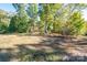 Expansive backyard with mature trees, offering a serene setting and ample space at 5039 Penn Rd, Iron Station, NC 28080