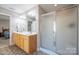Bathroom with a double vanity and a glass-enclosed shower at 5039 Penn Rd, Iron Station, NC 28080