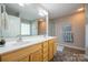 Well-lit bathroom featuring double sink vanity, large mirror, and neutral-colored walls at 5039 Penn Rd, Iron Station, NC 28080