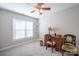 Comfortable bedroom with a ceiling fan, window, desk, and sitting area at 5039 Penn Rd, Iron Station, NC 28080