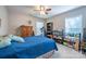 Comfortable bedroom features a ceiling fan, dresser, and bookshelf at 5039 Penn Rd, Iron Station, NC 28080