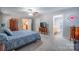 Bedroom featuring a ceiling fan, three dressers, and a bathroom at 5039 Penn Rd, Iron Station, NC 28080