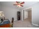 Comfortable bedroom with a ceiling fan, desk, and book shelf at 5039 Penn Rd, Iron Station, NC 28080