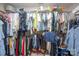 Walk-in closet is packed with clothing items on multiple racks and shelves at 5039 Penn Rd, Iron Station, NC 28080
