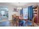 Dining room with elegant wooden table, matching chairs, and a window with blue curtains at 5039 Penn Rd, Iron Station, NC 28080