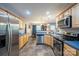 Bright kitchen features stainless steel appliances, wooden cabinets, and a view to the dining area at 5039 Penn Rd, Iron Station, NC 28080