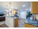 This kitchen has wooden cabinets, stainless steel appliances and an open view into the Gathering room at 5039 Penn Rd, Iron Station, NC 28080