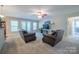 Spacious living room features a ceiling fan, neutral color scheme, and access to the backyard at 5039 Penn Rd, Iron Station, NC 28080