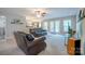 Bright living room featuring neutral paint, access to a patio, and comfortable seating arrangement at 5039 Penn Rd, Iron Station, NC 28080
