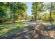 View of the property showing trees, and a gravel path leading to another building at 5039 Penn Rd, Iron Station, NC 28080