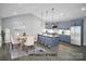 Virtually staged dining area and kitchen with gray cabinets and hardwood floors at 7066 Sparrow Ln, Vale, NC 28168