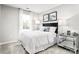 Cozy bedroom with a white bed, mirrored nightstand, and soft gray carpet at 1933 Stephens Farm Dr, China Grove, NC 28023