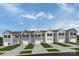 Row of charming townhouses with gray and beige siding, two-car garages, and well-manicured lawns at 1933 Stephens Farm Dr, China Grove, NC 28023