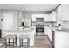 Spacious kitchen boasts white cabinets, granite countertops, stainless steel appliances and breakfast bar at 1933 Stephens Farm Dr, China Grove, NC 28023