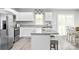 Bright kitchen featuring white cabinetry, granite island, stainless steel appliances, and access to backyard at 1933 Stephens Farm Dr, China Grove, NC 28023