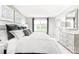 Bright and airy main bedroom with a gray upholstered bed, white linens, and large window at 1933 Stephens Farm Dr, China Grove, NC 28023