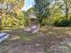 Spacious backyard with playset and wooded area at 316 Carter Rd, Monroe, NC 28110