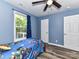 bedroom with a twin bed, window, and blue walls at 316 Carter Rd, Monroe, NC 28110