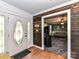 Entryway with wood accent wall, hardwood floors, and view into living room at 316 Carter Rd, Monroe, NC 28110