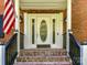 Brick front entrance with a white door and black railings at 316 Carter Rd, Monroe, NC 28110