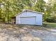 Detached garage with white siding and double doors at 316 Carter Rd, Monroe, NC 28110