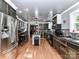 Kitchen with dark wood cabinets, granite island, and stainless steel appliances at 316 Carter Rd, Monroe, NC 28110