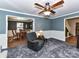 Living room with gray walls, carpet, and view into dining room and upstairs at 316 Carter Rd, Monroe, NC 28110