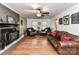 Living room with hardwood floors, a wood-burning stove and comfortable seating at 316 Carter Rd, Monroe, NC 28110